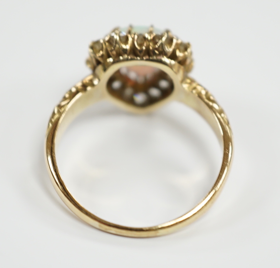 A yellow metal, white opal and diamond set heart shaped cluster ring, size N, gross weight 3.7 grams.